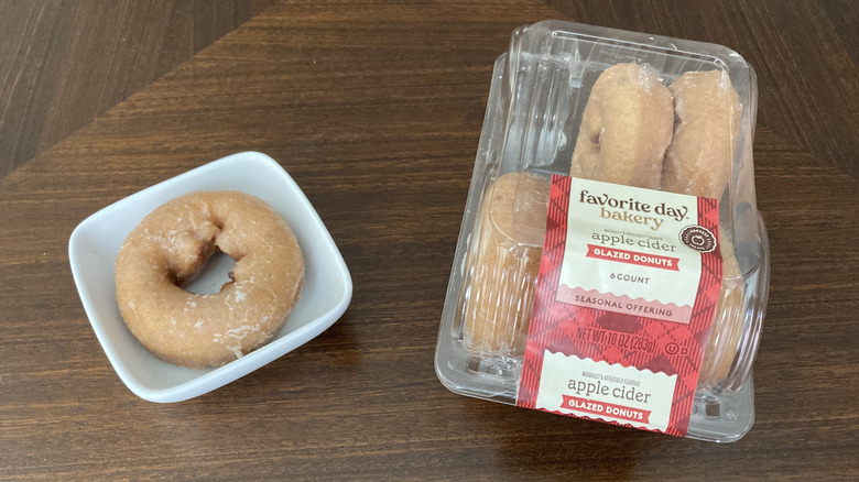 Favorite Day apple cider donuts in a package next to one on a mini plate