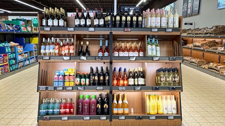 A display with assorted wine bottles inside an Aldi store.