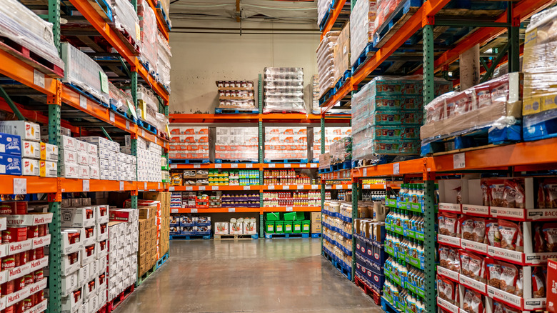 Inside of a Costco store with shelves stacked high with various food and drink products