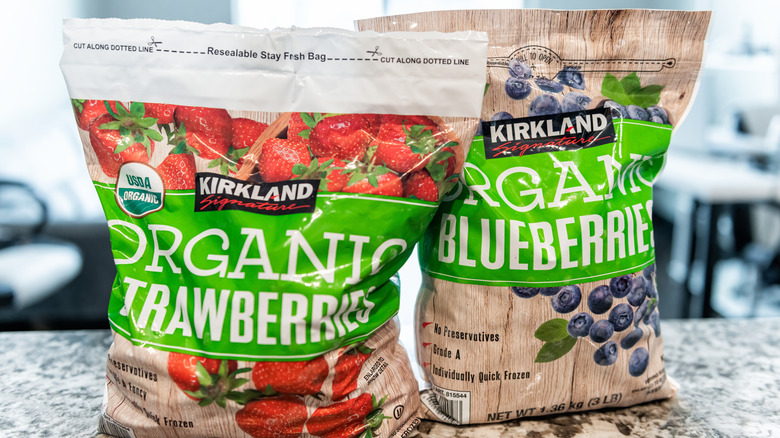 Bags of Kirkland Signature organic strawberries and blueberries sit on a counter