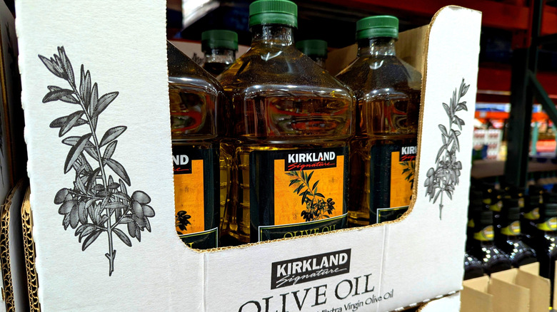Bulk-sized bottles of Kirkland Signature olive oil in a cardboard display tray