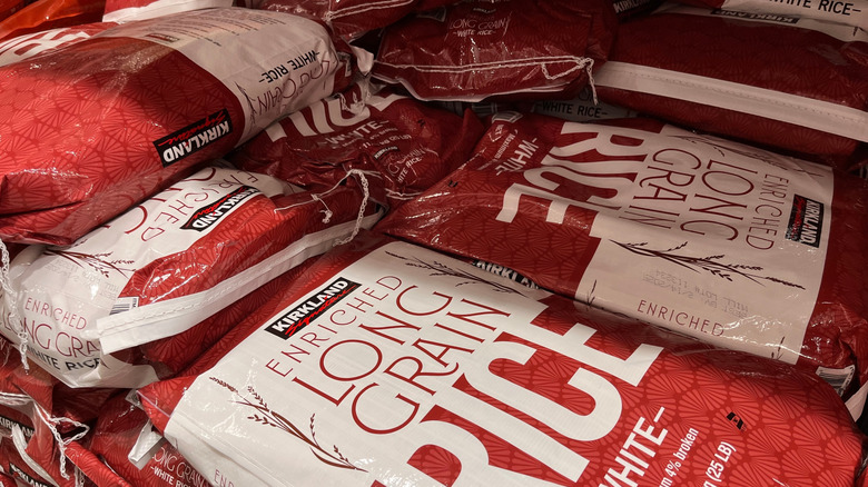 A stack of bulk-sized bags of Kirkland Signature enriched long grain rice