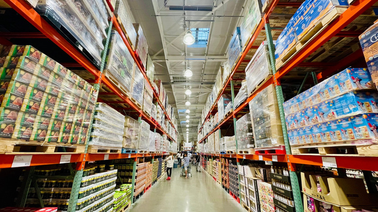 Shoppers browse through an aisle of bulk items at Costco