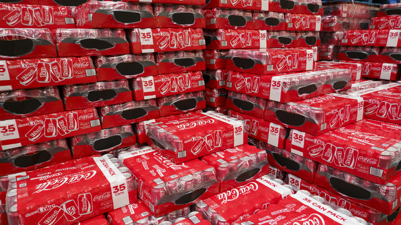 Several bulk-sized cases of Coca-Cola cans stacked at Costco.