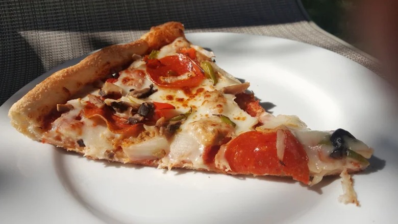 Sam's Club discontinued deluxe pizza slice on a white plate