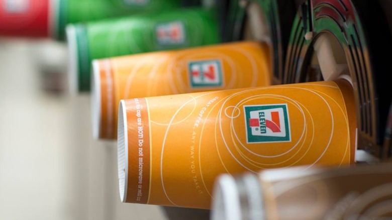 Colorful 7/11 cups sticking out of a machine