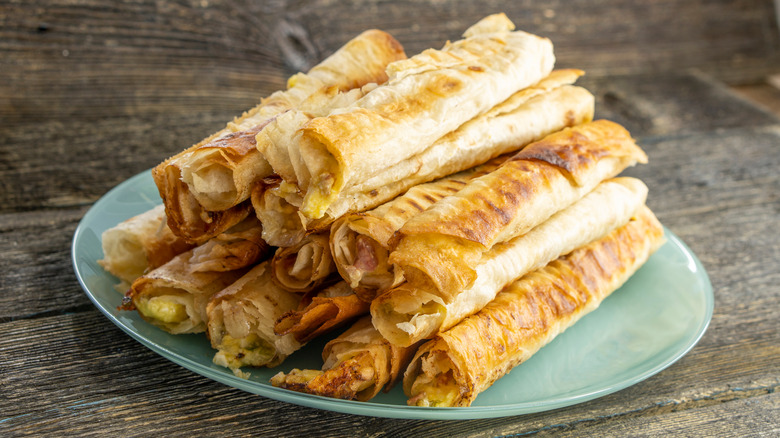 Taquitos on a green plate