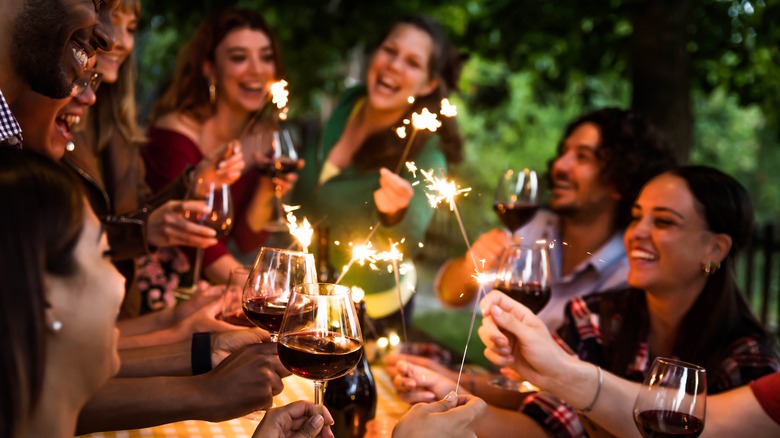 People toasting wine glasses