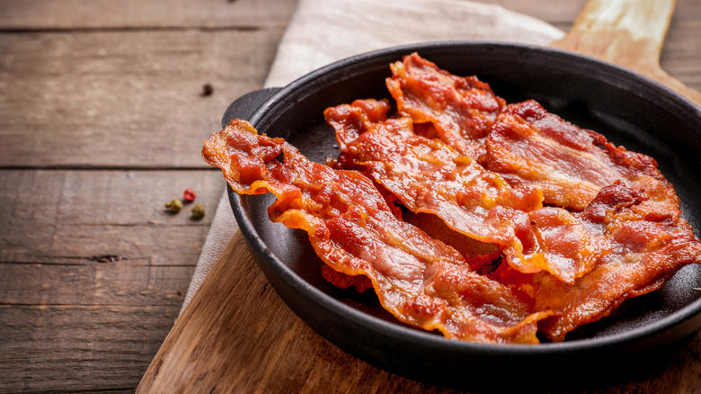 cooked bacon strips in a cast iron skillet