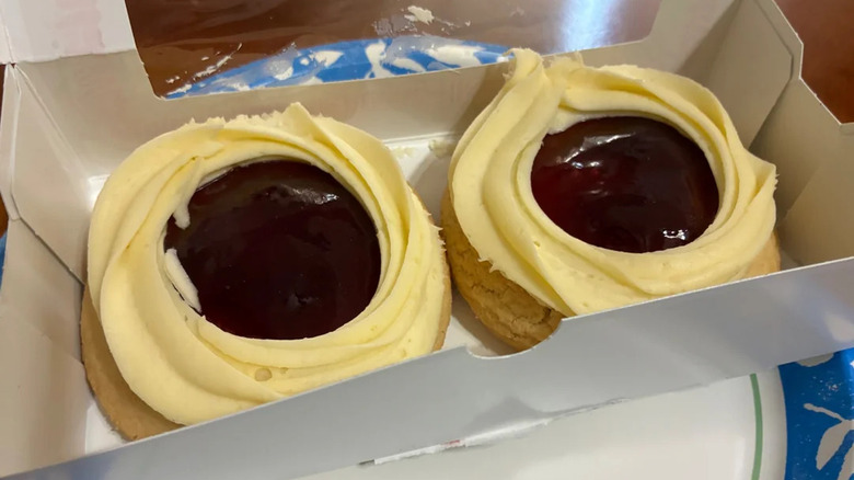 Two Decadent raspberry cream cheese cookies from Publix in a white box