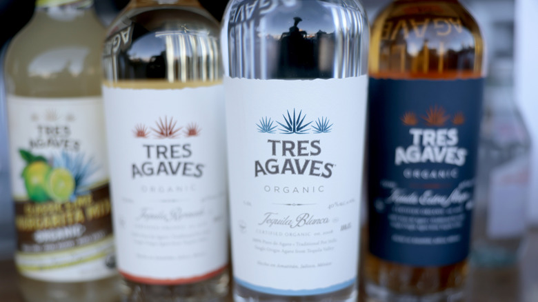 Three bottles of different types of Tres Agaves Organic plus a Tres Agaves margarita mix.