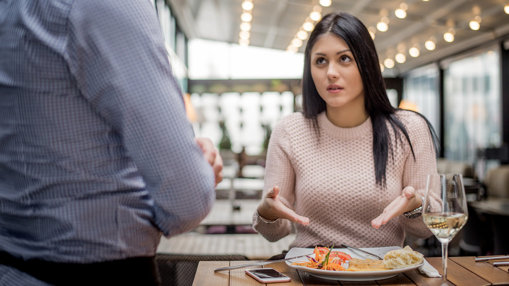 woman sending food back at restaurant