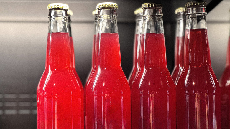 Bottles of red soda