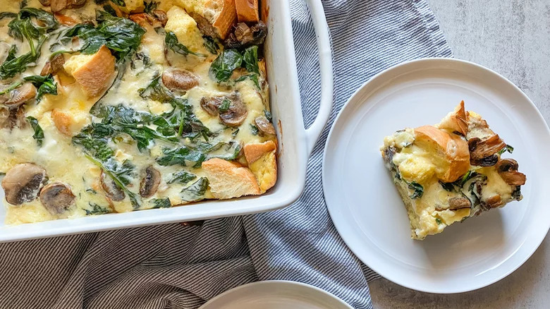 baking dish and plate with spinach and mushroom egg strata