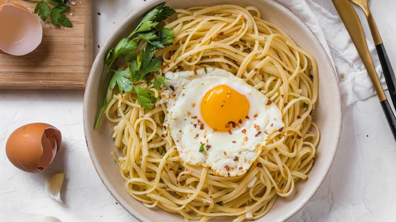 bowl of spaghetti and eggs with eggshells