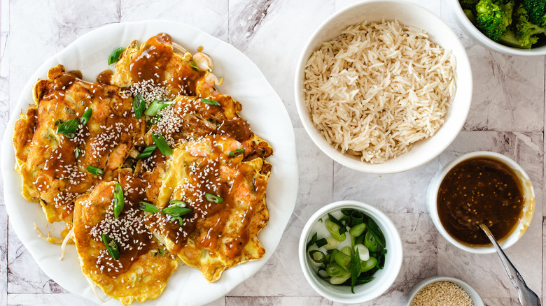 plate with egg foo young rice sauce garnishes