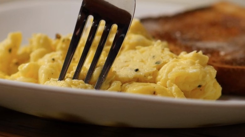 light and fluffy scrambled eggs with fork