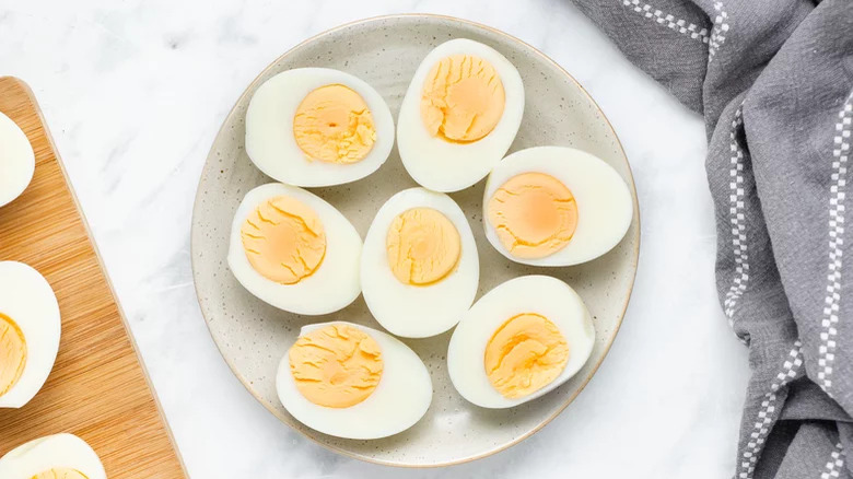 plate of hard boiled eggs with dish towel