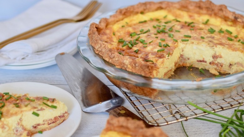 pie dish with quiche lorraine and serving utensil