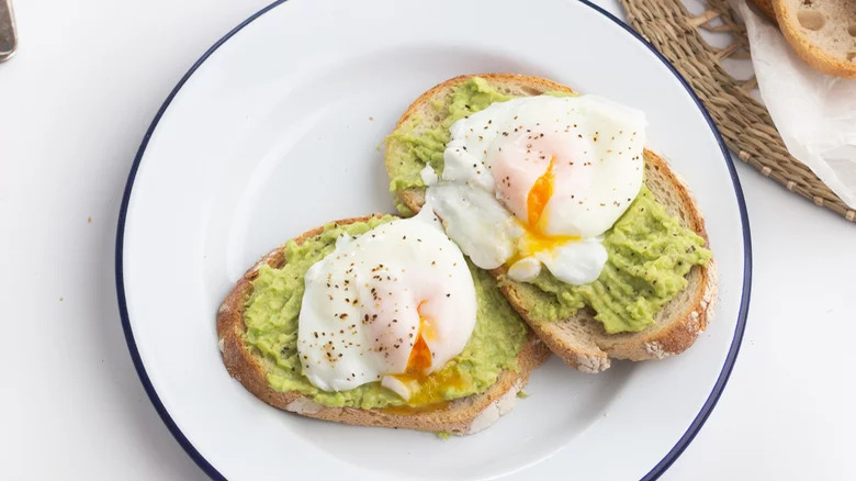 plate with poached egg and avocado toast