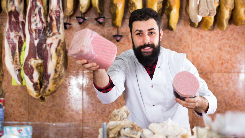 Butcher holding meat