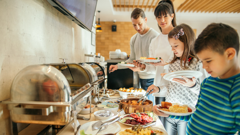 people in line for a breakfast buffet