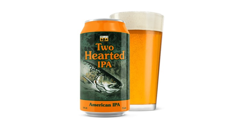 Can of Bell's Brewery Two Hearted IPA next to a filled pint glass on a white background