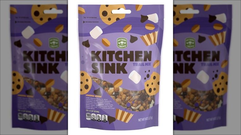 A bag of trail mix with several varieties of nuts and other treats.