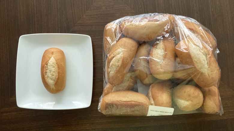 Petite hoagie rolls in a bag and one on a plate