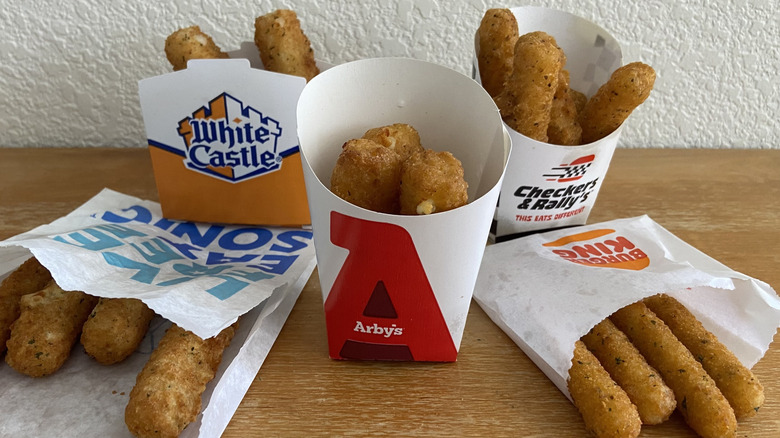 all five fast food mozzarella sticks in an array on a table