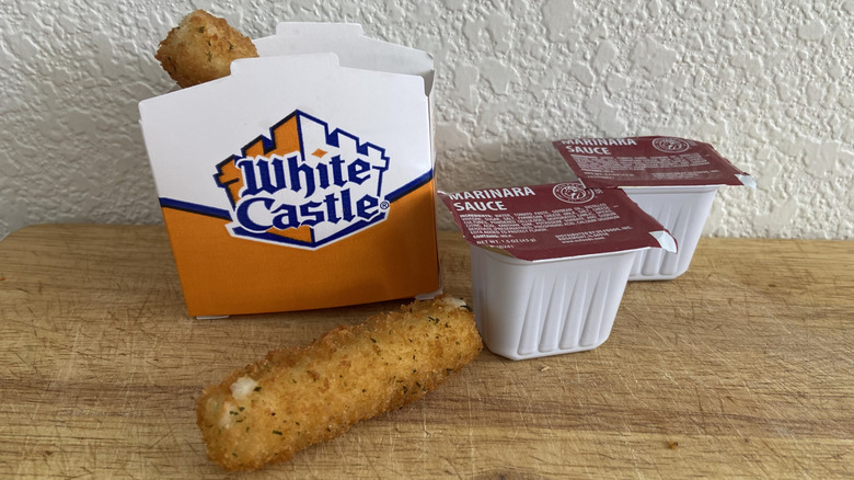 White Castle mozzarella sticks beside two marinara dipping cups