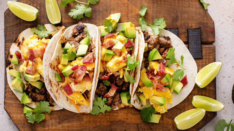 Breakfast tacos on a wooden board