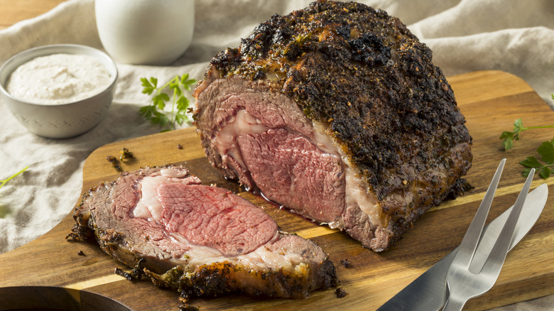 Prime rib on a wooden cutting board