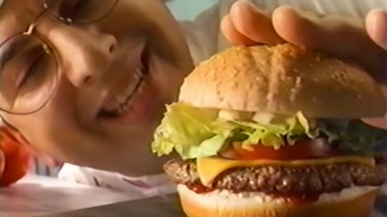 A chef with a McDonald's Arch Deluxe burger