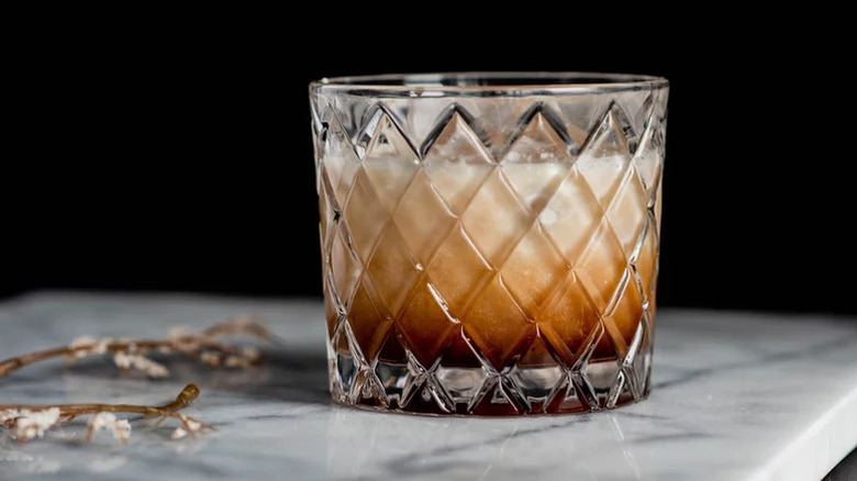 White Russian cocktail in diamond patterned rocks glass.