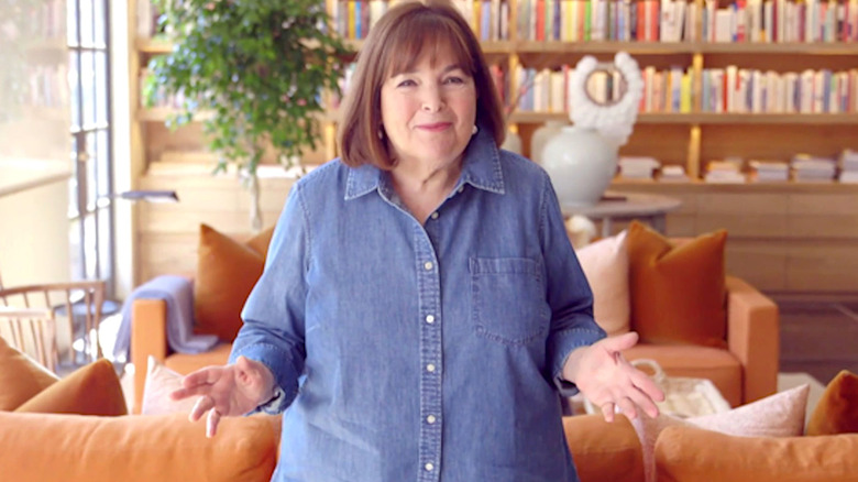 Ina Garten of Food Network fame in a living room, gesturing toward the camera