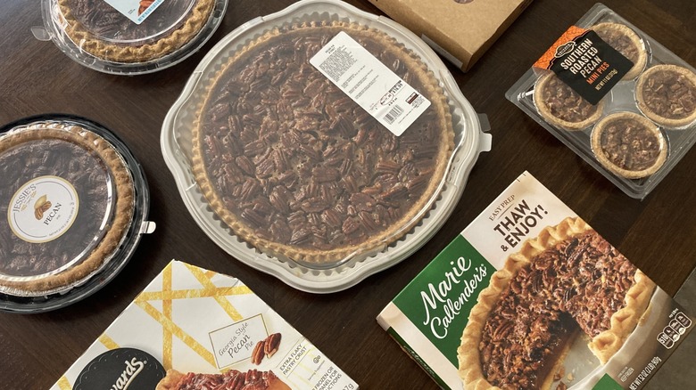 Several pecan pies from grocery stores in their packaging