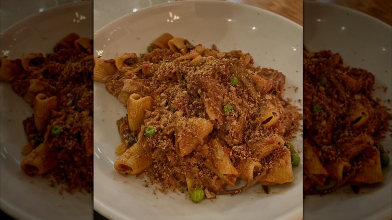 bowl of short rib pappardelle pasta topped with parmesan cheese