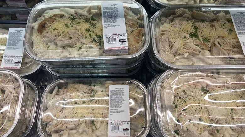 a handful of chicken Alfredo packages on a shelf