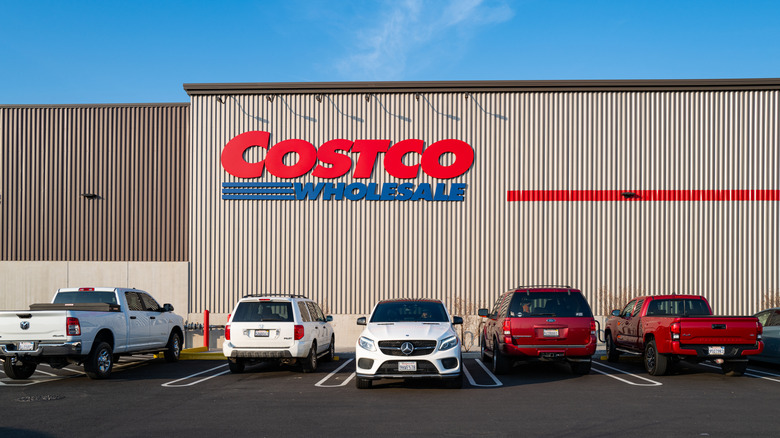Costco warehouse behind five parked cars