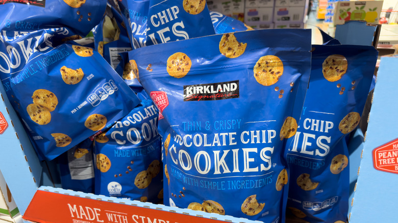 A box contains bags of the Kirkland Signature Thin & Crispy Chocolate Chip Cookies.