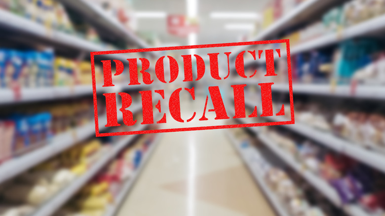 grocery aisle with product recall sign