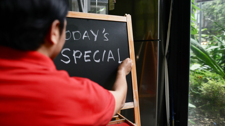 restaurant staff writing special menu