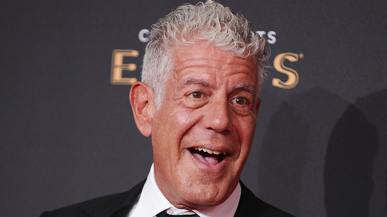 Anthony Bourdain in suit, happy