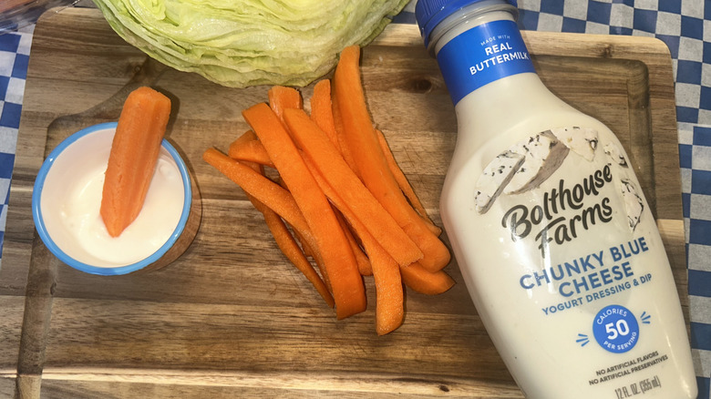 Bolthouse Farms blue cheese dressing, carrots, lettuce and a carrot stick in the dip