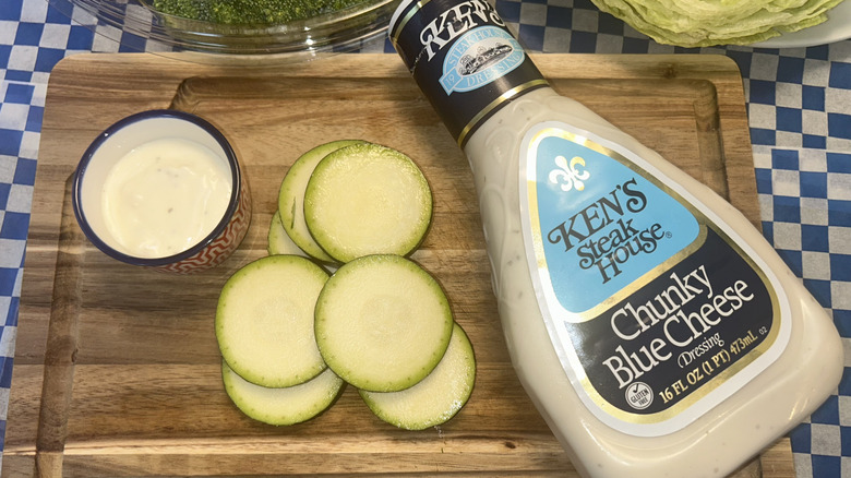 Bottle of Ken's Steak House dressing, sliced zucchini and ramekin of dressing