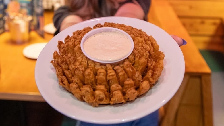 server holding a cactus blossom at Texas Roadhouse