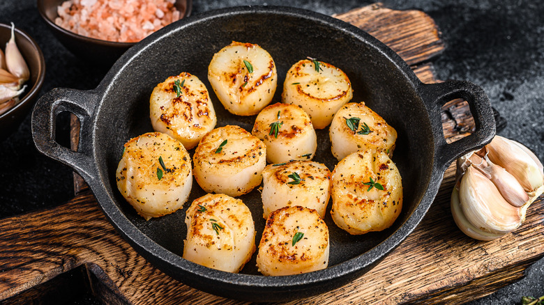 fried scallops with butter sauce in a pan