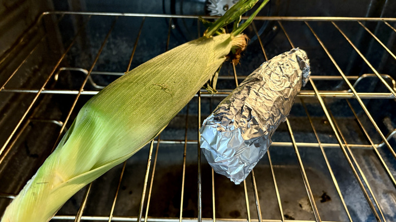 Two ears of corn in the oven, one in foil