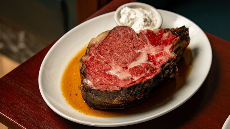 Close-up of plated prime rib with sauce from 801 Chophouse.